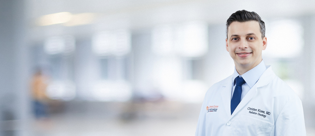 Dr. Kluwe in a white coat and tie smiling