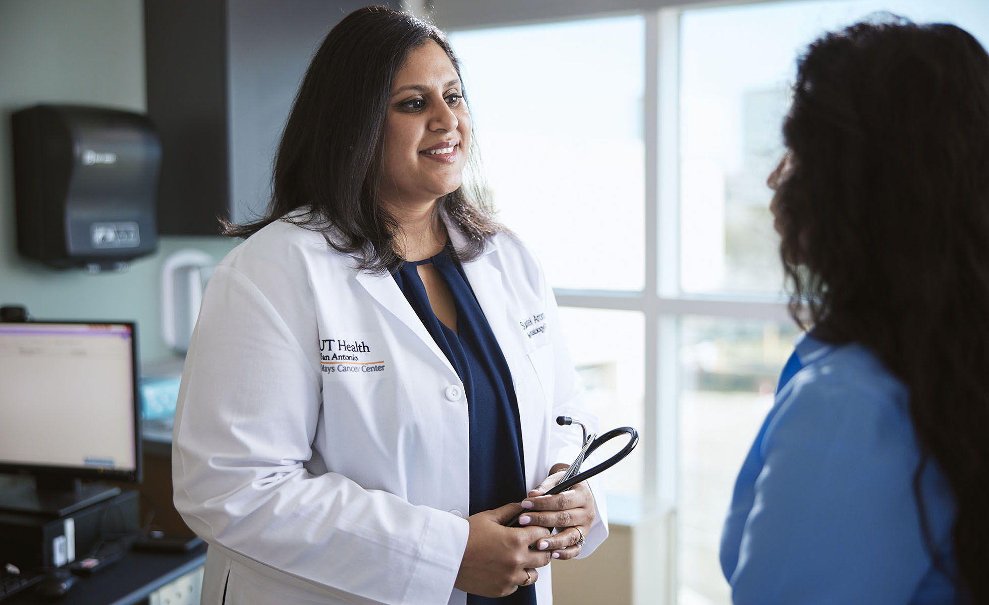 Dr. Arora talking to a patient 