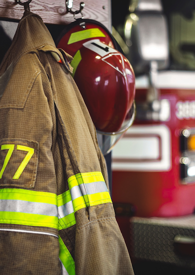 Firefighter uniform with firetruck in the background