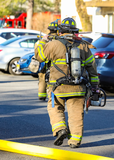 Firefighters walking in a parking lot