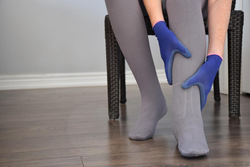 A person that has swollen legs with compression socks on 
